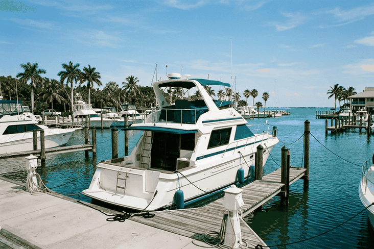 Motor cruiser yacht backed into a slip at a coastal marina