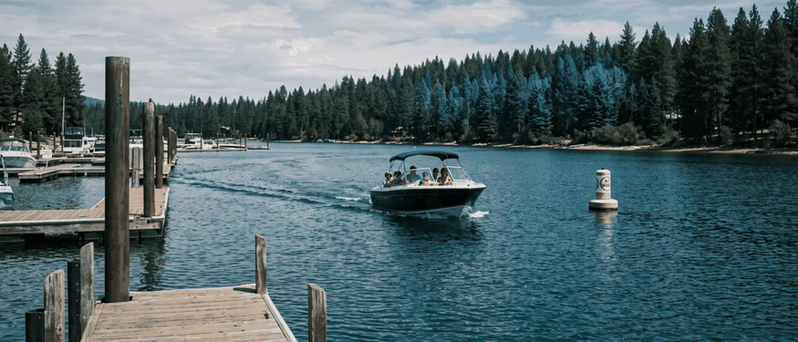 Family powerboat leaving a no wake zone on a large lake, a boat Progressive boat insurance could cover